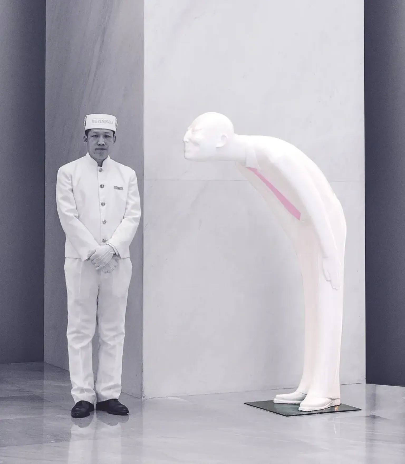 A greeter stands before one of Gao Xiao Wu’s fiberglass creations at the entrance to the Peninsula Beijing (photo by Peter Guenzel).